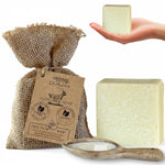 Dr. Ancient goat milk soap with packaging and a bar of soap held by a hand on a white background