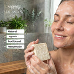 Woman holding a bar of soap with 'Dr. Ancient' branding, set against a bathroom background.
