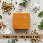 Bar of soap on a textured surface with natural ingredients and Dr. Ancient logo.