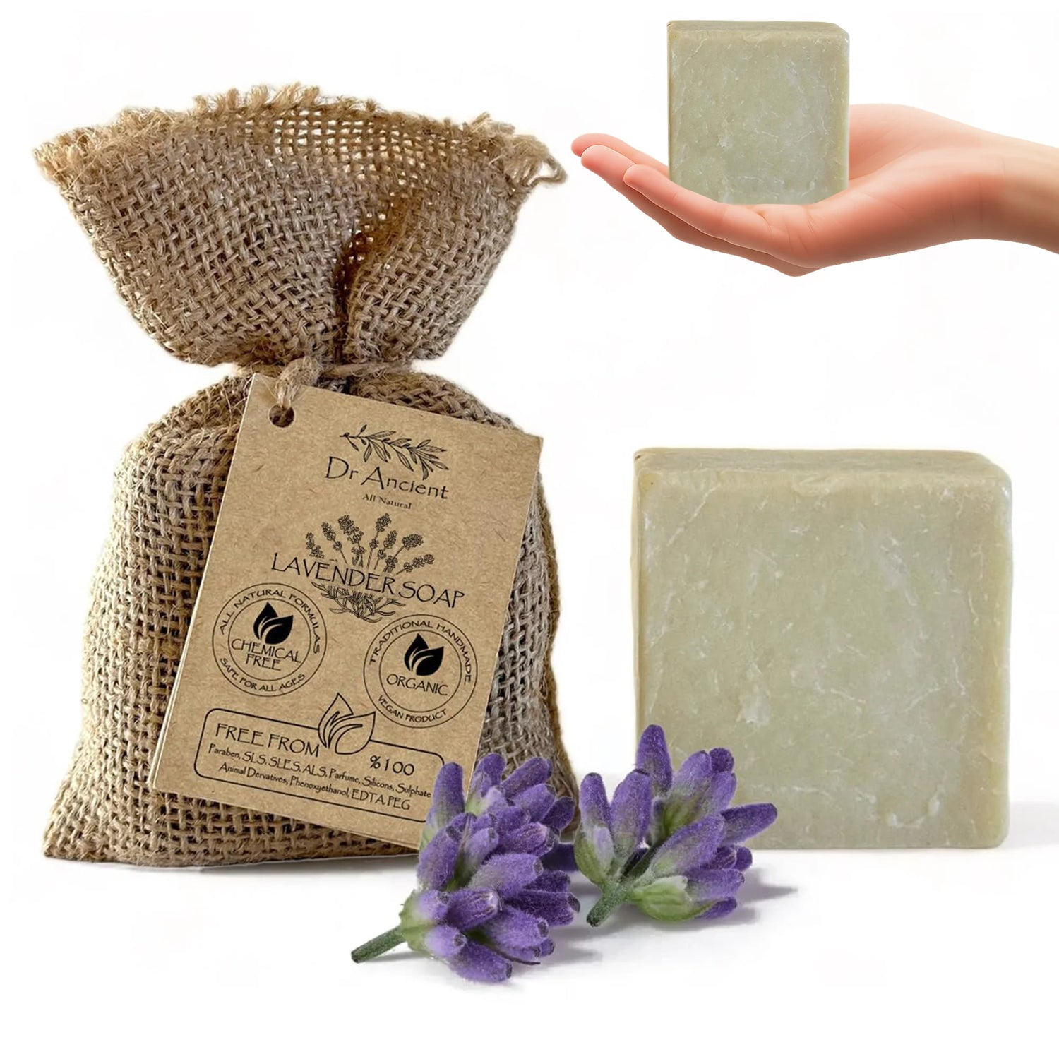 Lavender soap in a burlap bag with a hand holding a bar of soap and lavender flowers on a white background.