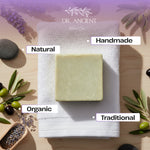 Bar of soap on a towel with 'Dr. Ancient' branding, surrounded by natural elements like lavender and olives.