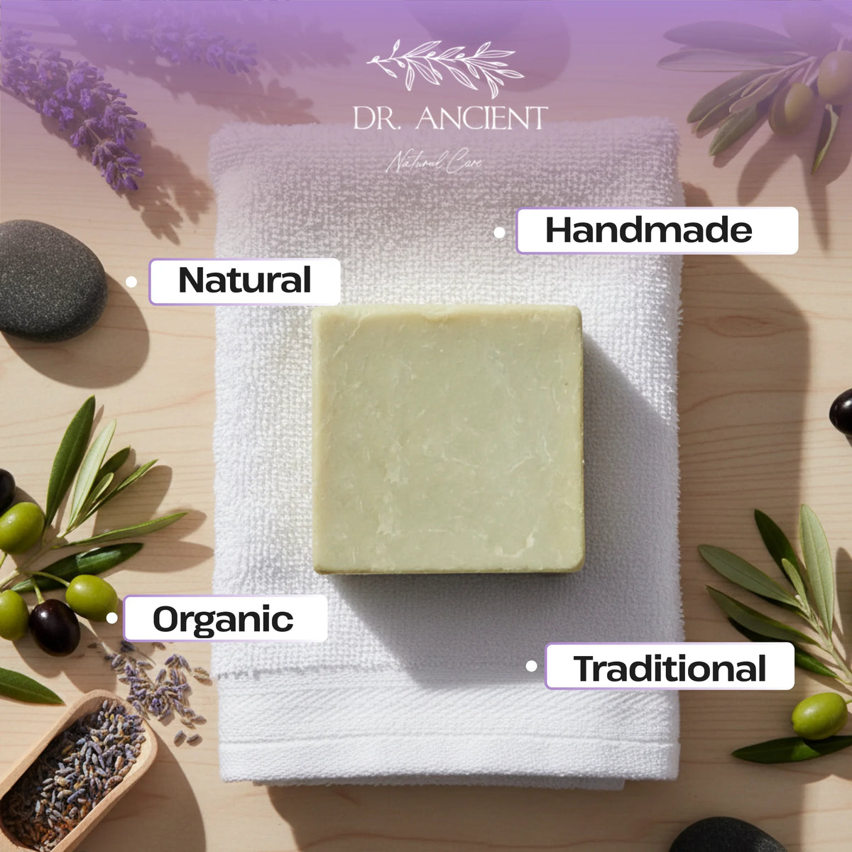 Bar of soap on a towel with 'Dr. Ancient' branding, surrounded by natural elements like lavender and olives.