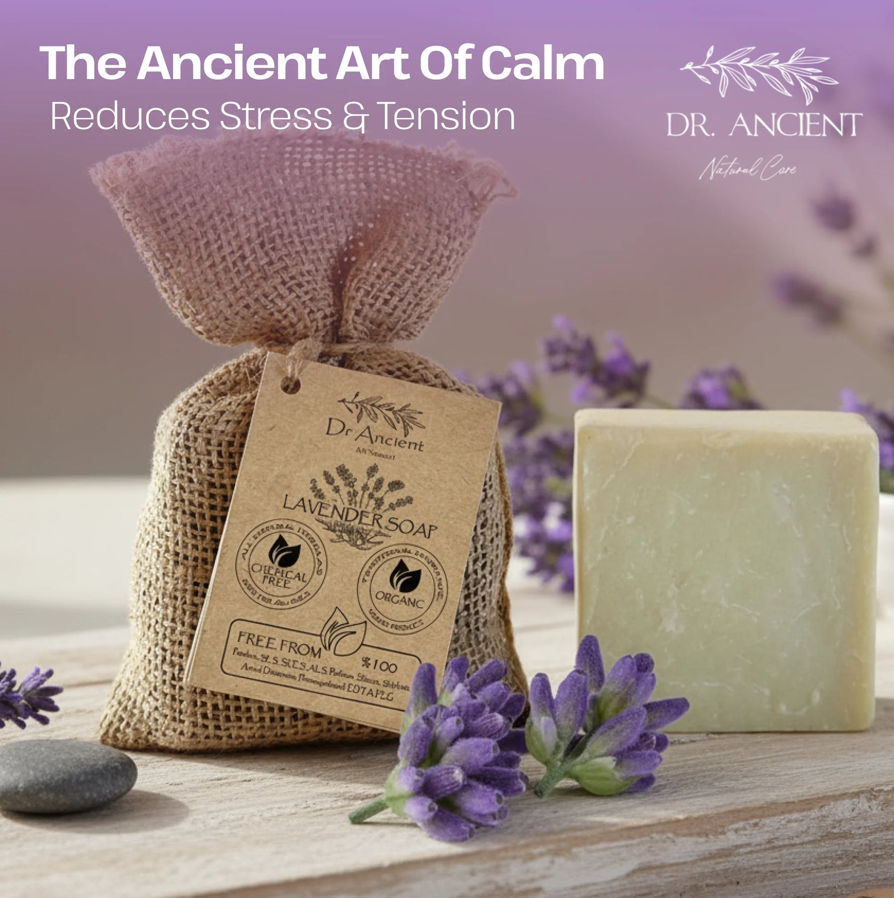 A bar of lavender soap stands beside a burlap gift bag with a kraft tag, styled with purple flowers on a wooden surface against a soft lavender background. Text at the top reads 'The Ancient Art Of Calm Reduces Stress & Tension' and 'DR.
