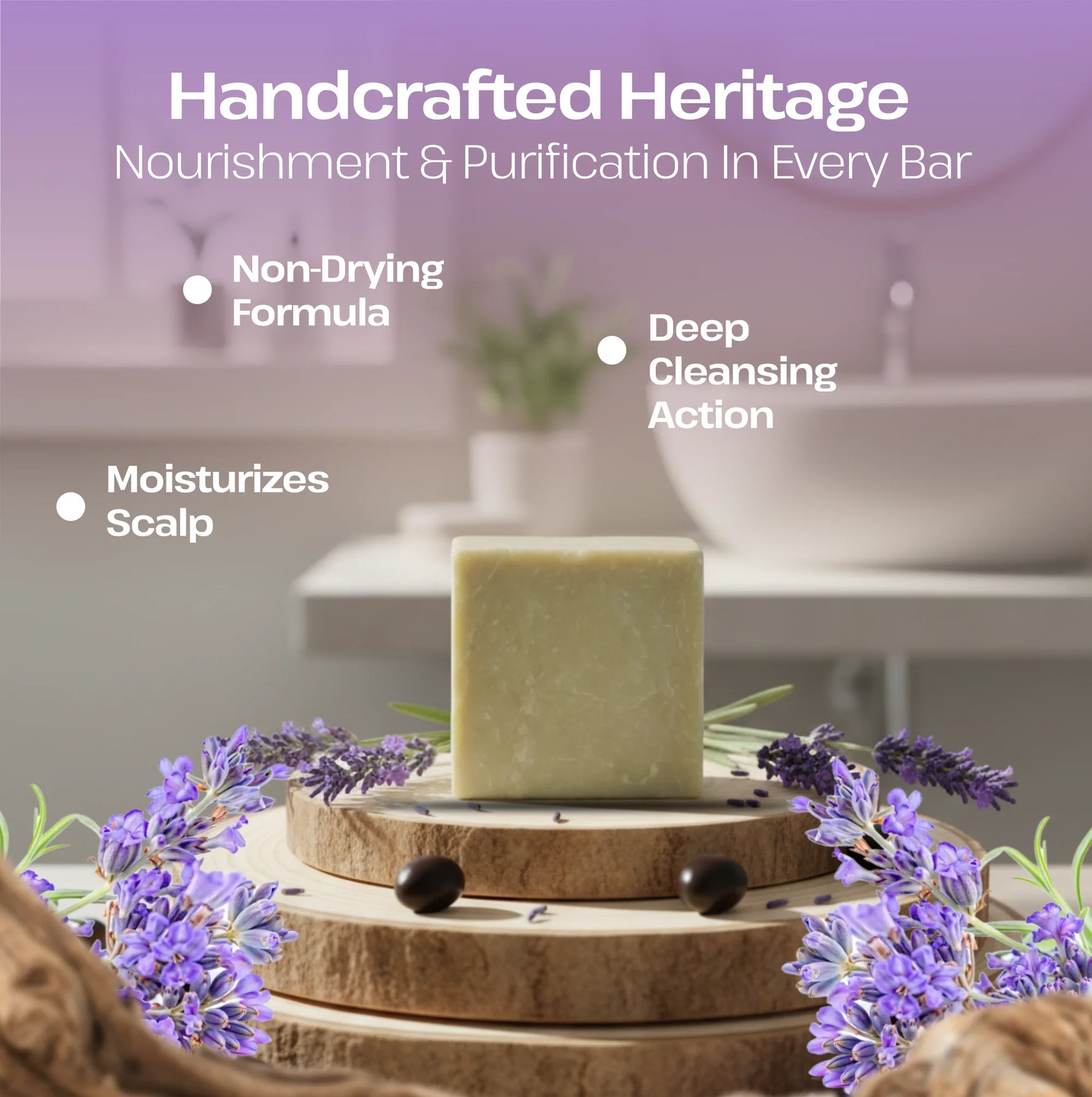 A handcrafted rectangular bar of pale yellow-green soap stands on stacked wood slices, surrounded by purple lavender flowers and small dark beads. The background is a softly blurred bathroom setting with white text overlays reading 'Handcrafted Heritage' and feature callouts including 'Non-Drying Formula,' 'Moisturizes Scalp,' and 'Deep Cleansing Action.