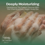 Promotional graphic for Dr. Ancient Natural Cosmetics featuring a close-up of hands lathered with thick white foam, with the headline 'Deeply Moisturizing' and product copy on a soft green gradient background.