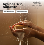 A promotional skincare image showing a person's hands washing a rectangular soap bar under running water, with foam dripping down. Text at the top reads 'Ageless Skin, Naturally' and 'Deep Moisturization' and 'Softens & Smooths,' with the Dr.