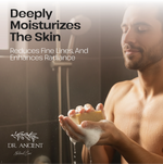 Man holding a bar of soap with text about skin care benefits and Dr. Ancient branding.