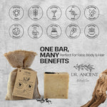 A bar of natural soap displayed next to a burlap bag with a paper tag, on a textured light gray background with product benefit icons and the brand name Dr. Ancient Natural Care.