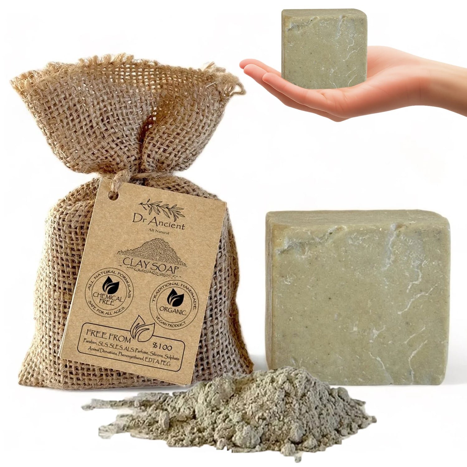 A bar of Dr. Ancient Clay Soap is shown alongside its burlap bag packaging with a paper tag, a small pile of the soap powder, and a human hand holding a smaller bar in the upper right corner.