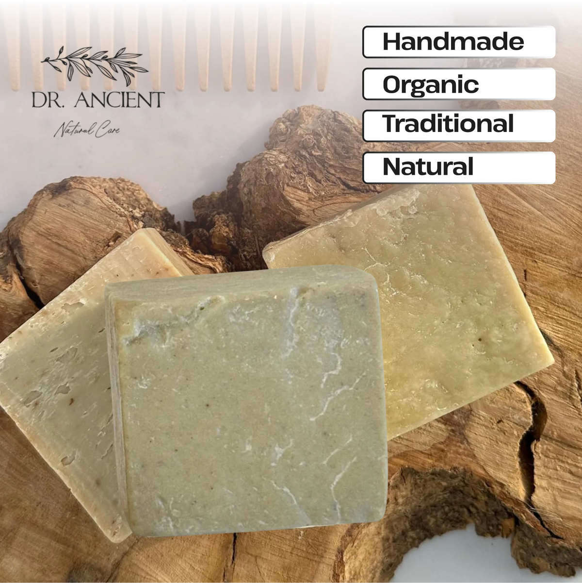 Three handmade rectangular bars of soap displayed on a rustic wood surface, with a white comb and text labels reading Handmade, Organic, Traditional, and Natural. The brand name Dr.