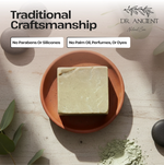 Bar of soap on a terracotta dish with 'Dr. Ancient' branding and product claims.