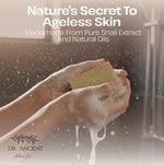 A promotional skincare graphic with the text 'Nature's Secret To Ageless Skin' and 'Handmade From Pure Snail Extract And Natural Oils' over a photo of hands washing with soap foam. The brand name 'DR.