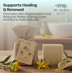 Dr. Ancient soap with packaging on a wooden surface with flowers and text about healing and renewal.