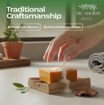 Hand pouring liquid soap onto a bar of soap on a wooden stand with 'Dr. Ancient' branding.