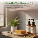 A styled bathroom or spa setting with two amber pump bottles labeled Shampoo and Conditioner, a rectangular bar of yellow-orange soap on a wood slice, a small potted fern, and overlaid marketing text reading 'Gentle Yet Powerful' and 'Free From Parabens, SLS, SLES, Silicones, PEGs, Palm Oil' with the brand DR. ANCIENT Natural Care.