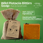 A bar of orange-brown handmade soap next to a burlap sack with a paper tag, on a green background with text reading 'Wild Pistacia Bittim Soap' and 'Dr. Ancient Natural Care'.