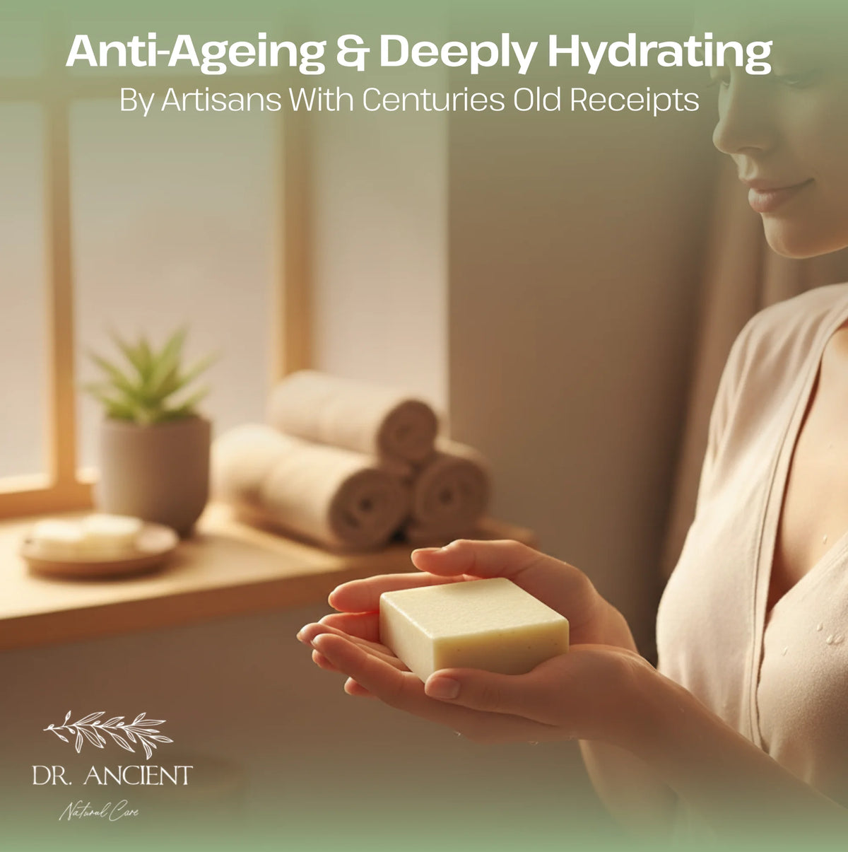 A woman in a beige robe holds a rectangular bar of pale yellow soap in her hands, with a softly lit spa-like interior in the background. Large text at the top reads 'Anti-Ageing & Deeply Hydrating By Artisans With Centuries Old Receipts,' and the brand 'DR.