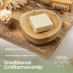 Bar of soap on a wooden dish with decorative elements and branding text.