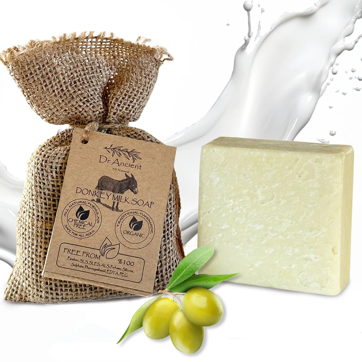 A bar of Dr. Ancient Donkey Milk Soap shown next to its burlap pouch packaging with a kraft paper tag, and green olives on a white background with a milk splash graphic.