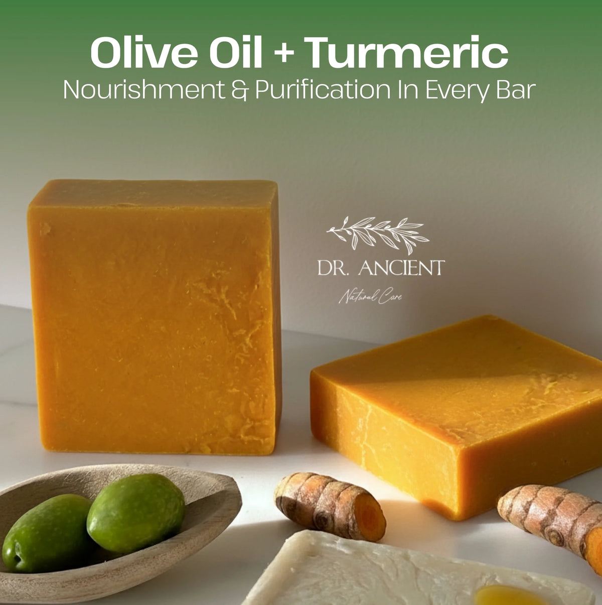 Two bars of olive oil and turmeric soap with turmeric root and leaves on a white background, featuring Dr. Ancient logo.